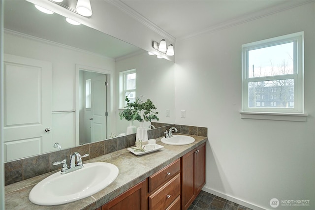 bathroom with a sink, baseboards, double vanity, and crown molding