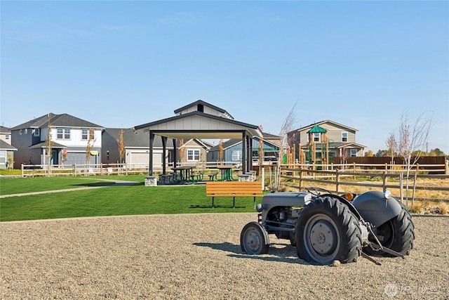 exterior space with a yard, a residential view, and fence