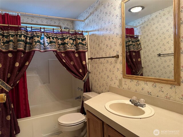 bathroom featuring wallpapered walls, shower / bath combination with curtain, toilet, and vanity