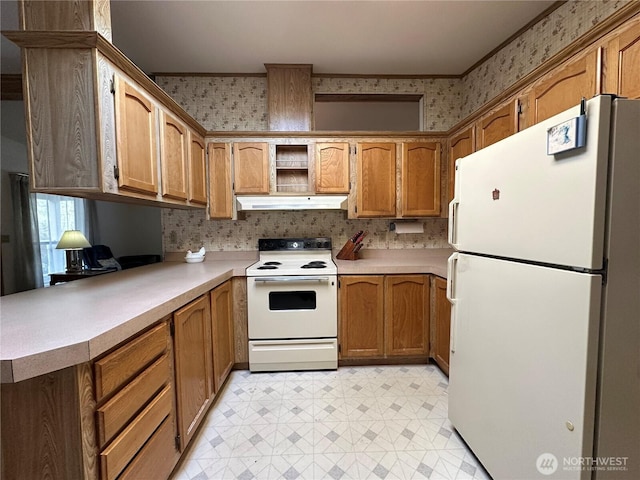 kitchen featuring white appliances, light floors, wallpapered walls, light countertops, and under cabinet range hood