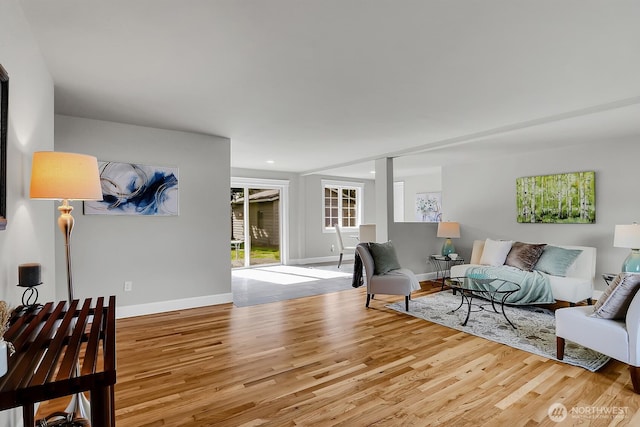 living room with light wood-style flooring and baseboards