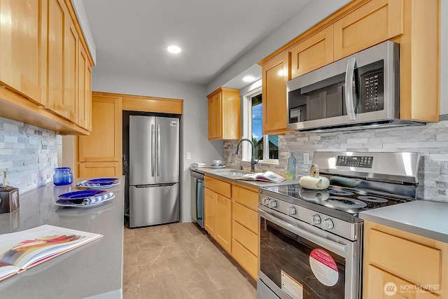 kitchen with stainless steel appliances, decorative backsplash, and light brown cabinets