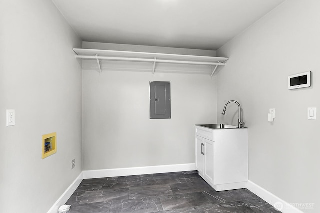 laundry area featuring hookup for a washing machine, electric panel, baseboards, and a sink