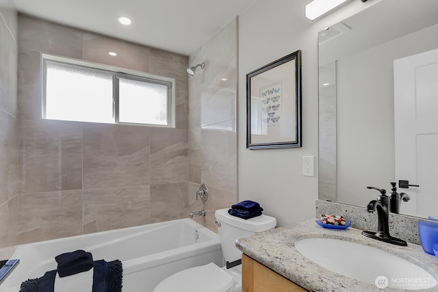 bathroom featuring vanity, toilet, and shower / tub combination