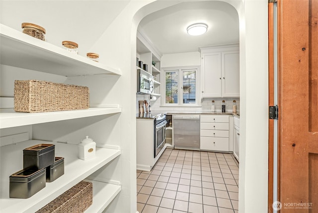 kitchen with open shelves, backsplash, stainless steel appliances, white cabinets, and light tile patterned floors