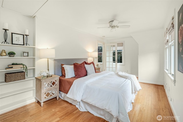 bedroom with light wood-style flooring, baseboards, and a ceiling fan