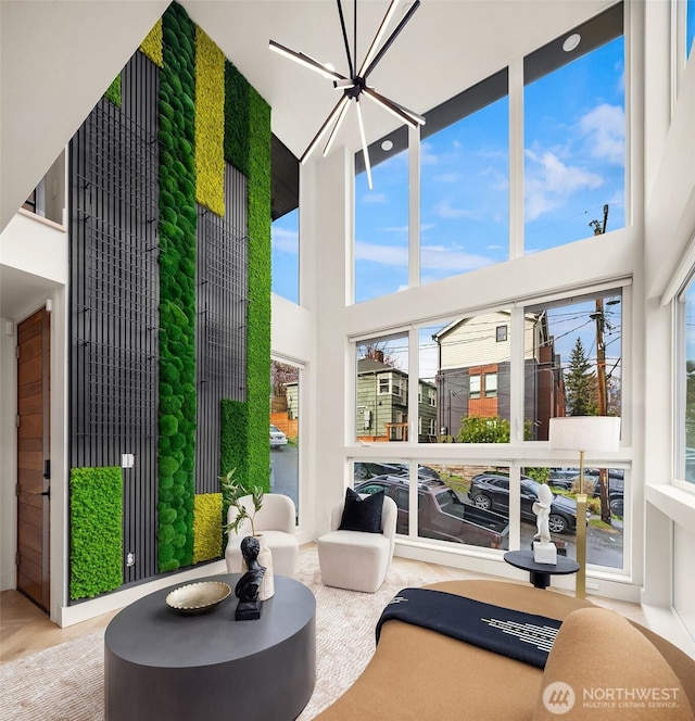 sunroom / solarium featuring a chandelier