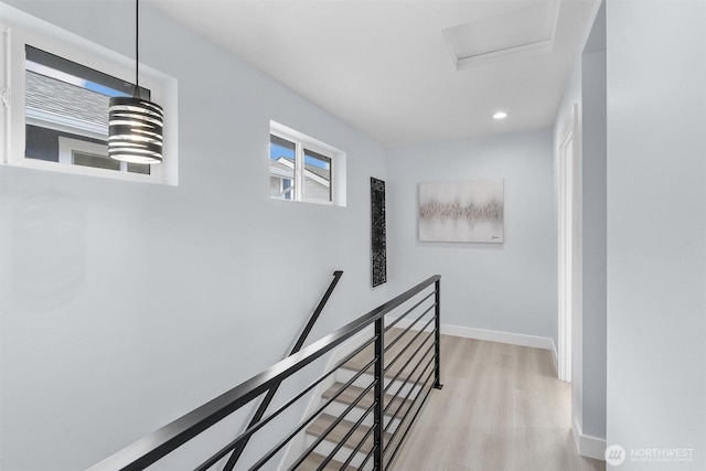 hallway featuring an upstairs landing, light wood-style flooring, recessed lighting, baseboards, and attic access