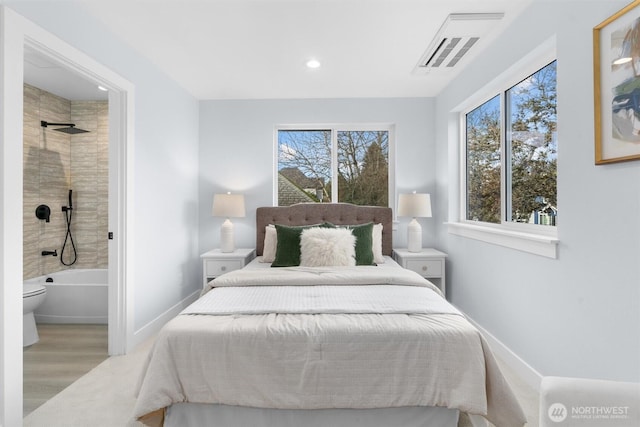 bedroom featuring recessed lighting, wood finished floors, baseboards, and connected bathroom