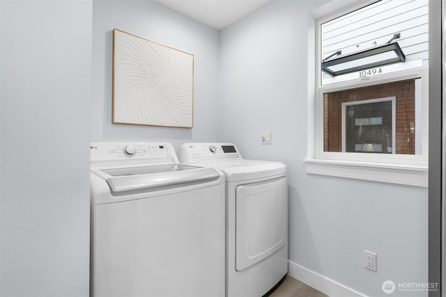 laundry area with laundry area, baseboards, and independent washer and dryer