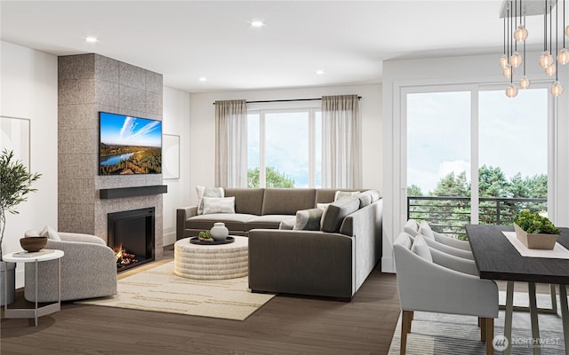 living area featuring dark wood finished floors, recessed lighting, and a tiled fireplace