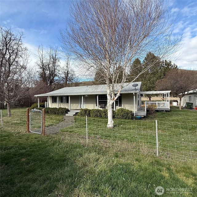 view of front of home with a front yard, a gate, and fence