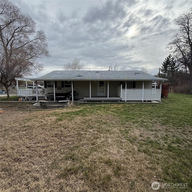 rear view of property with a lawn