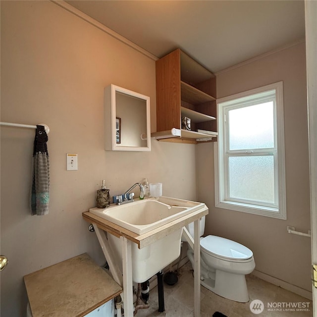 bathroom with toilet and a sink