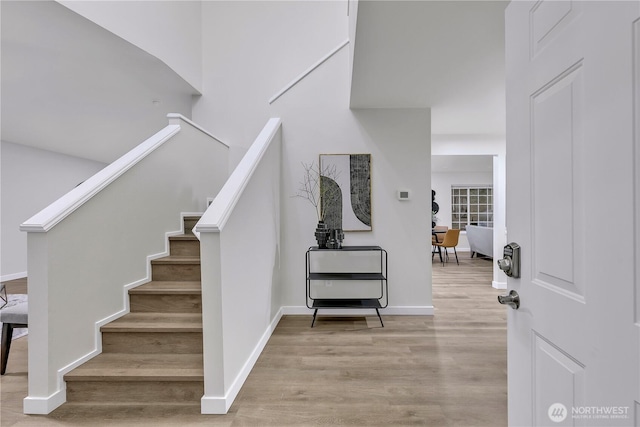 stairs with baseboards and wood finished floors