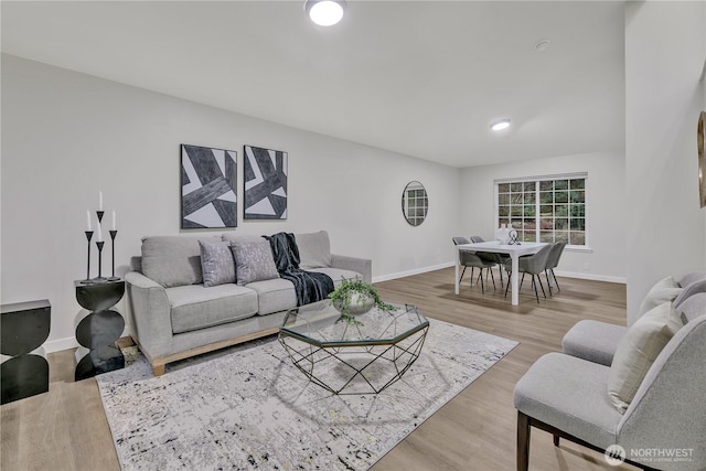 living room featuring baseboards and wood finished floors