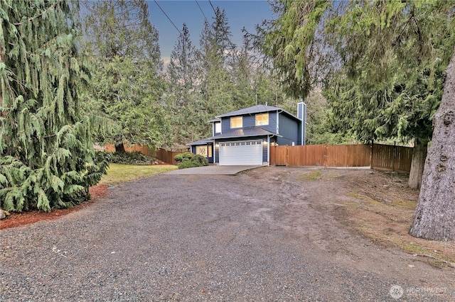 view of front of property with driveway and fence