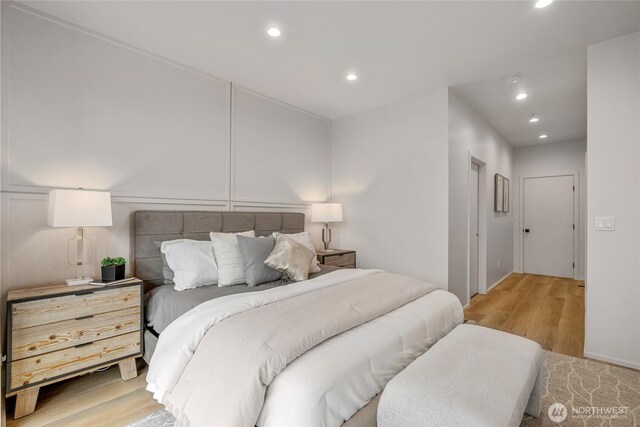 bedroom with recessed lighting and light wood finished floors