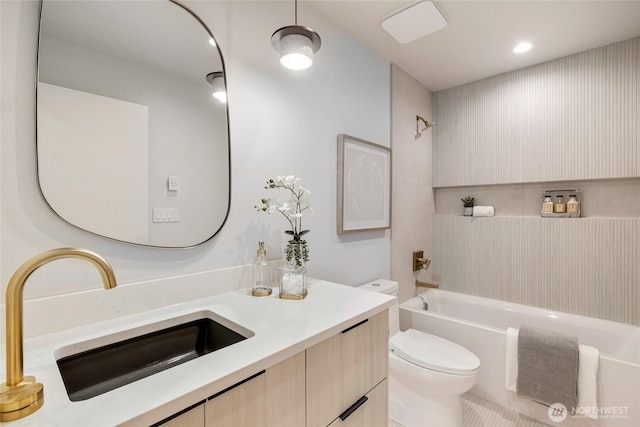 bathroom featuring vanity, bathing tub / shower combination, and toilet