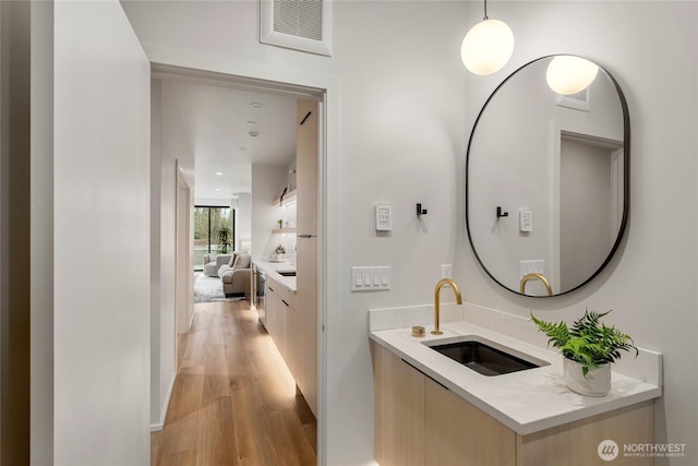 bathroom with vanity, wood finished floors, and visible vents