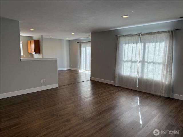 unfurnished room featuring dark wood finished floors, visible vents, recessed lighting, and baseboards