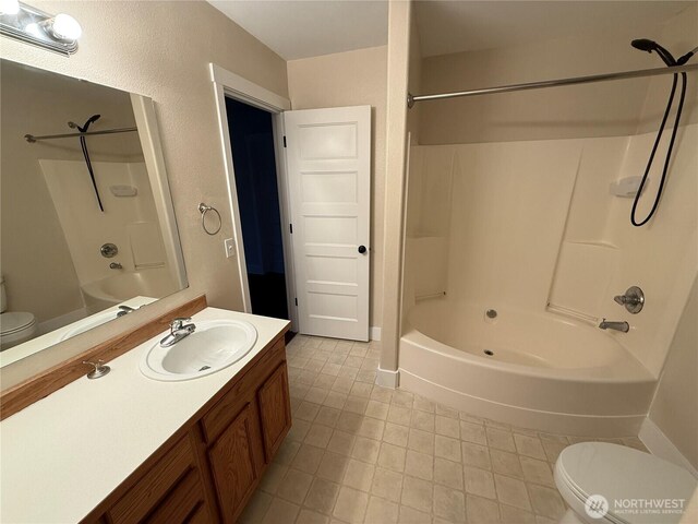 full bathroom with toilet, vanity, and washtub / shower combination