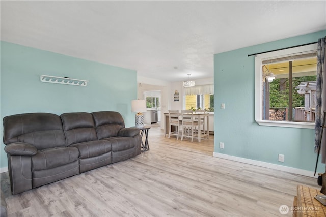 living room with baseboards and wood finished floors