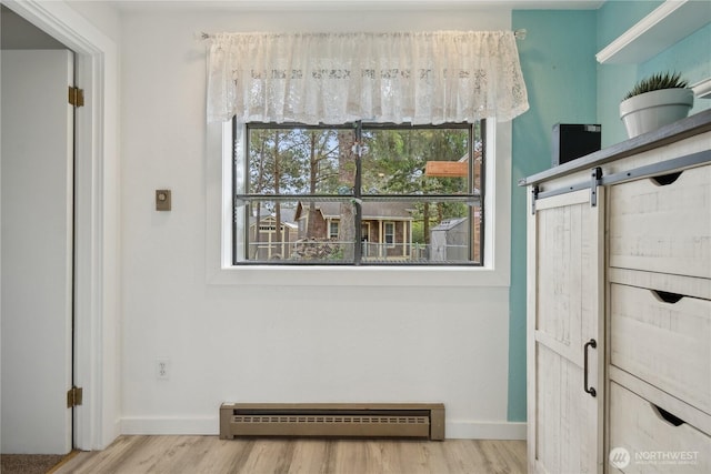 details featuring baseboards, baseboard heating, and wood finished floors