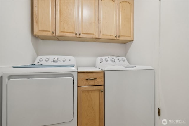 washroom with washing machine and clothes dryer and cabinet space