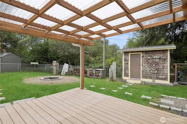 wooden terrace with a pergola, fence, a yard, a storage shed, and an outdoor structure