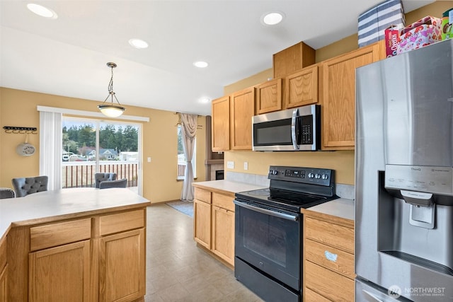 kitchen with recessed lighting, decorative light fixtures, appliances with stainless steel finishes, and light countertops