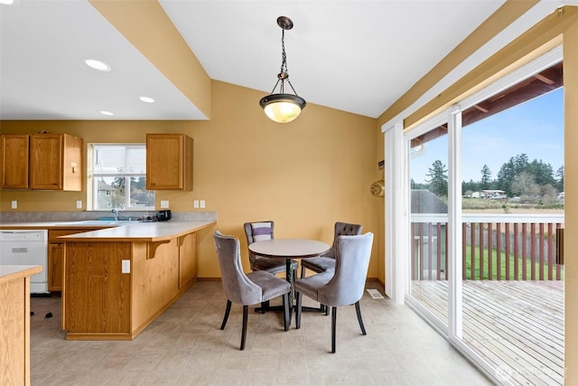 dining area with recessed lighting, light floors, and vaulted ceiling