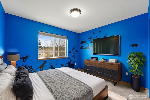 bedroom with baseboards and light carpet