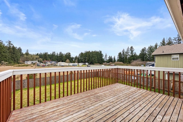 wooden deck featuring a yard and fence