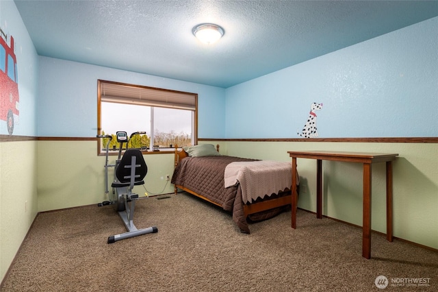 bedroom with carpet flooring and a textured ceiling