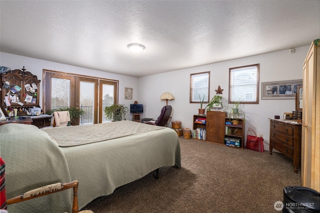 carpeted bedroom featuring a textured ceiling