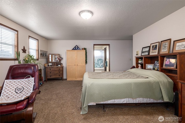 carpeted bedroom featuring a textured ceiling