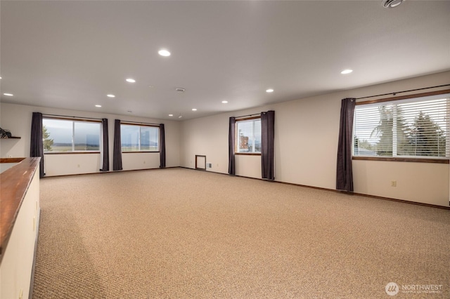 unfurnished room featuring recessed lighting, baseboards, and light colored carpet