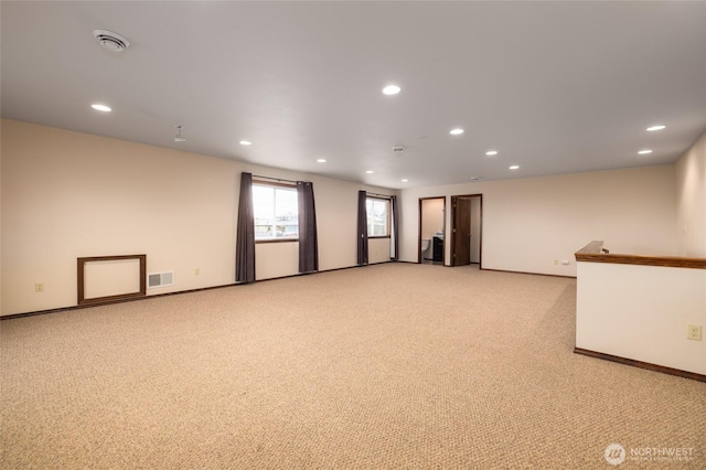 unfurnished room featuring baseboards, recessed lighting, visible vents, and light carpet