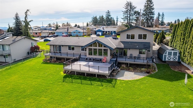 back of house featuring a storage unit, a residential view, and a wooden deck