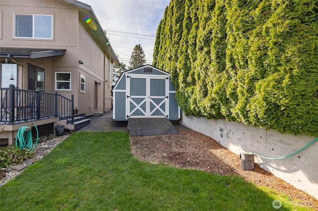 view of yard featuring a storage unit and an outbuilding