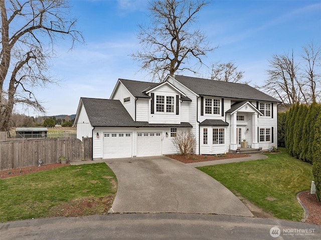 view of front of home with driveway, fence, a front yard, a shingled roof, and a garage