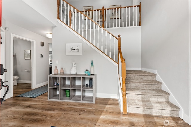 stairs featuring baseboards and wood finished floors