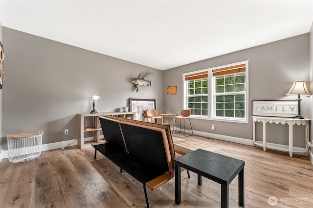 office space featuring baseboards and wood finished floors