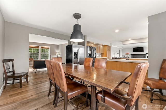 dining room with recessed lighting and light wood-style floors