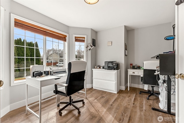 home office featuring baseboards and light wood-type flooring