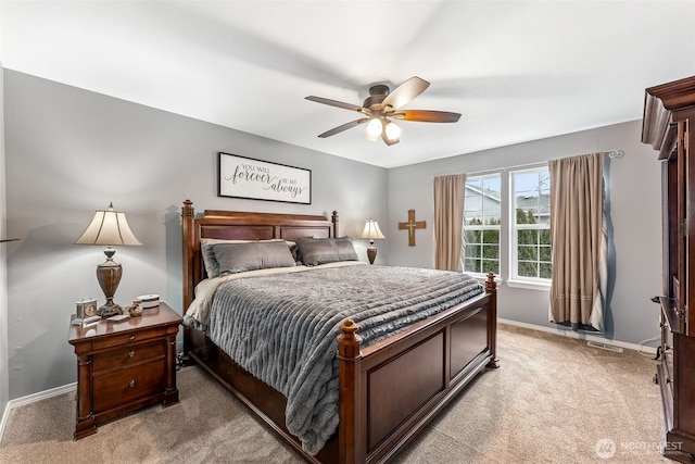 bedroom with ceiling fan, baseboards, and light carpet