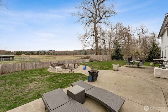 view of yard with outdoor dining area, a patio, and a fenced backyard