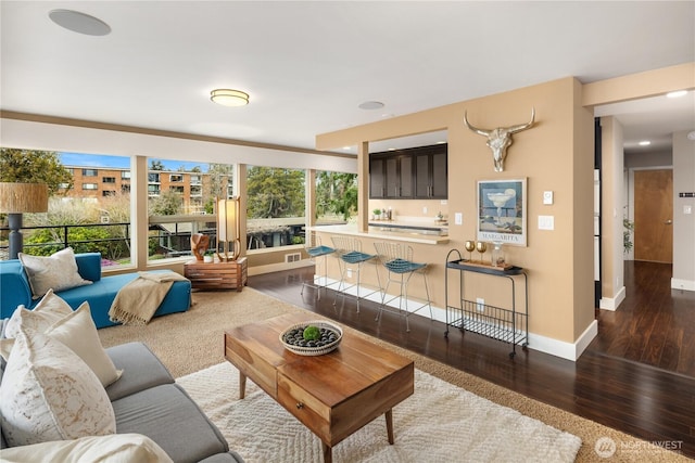 living room featuring baseboards and wood finished floors