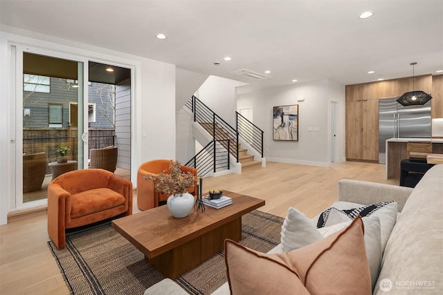 living area featuring visible vents, stairway, recessed lighting, and light wood-type flooring